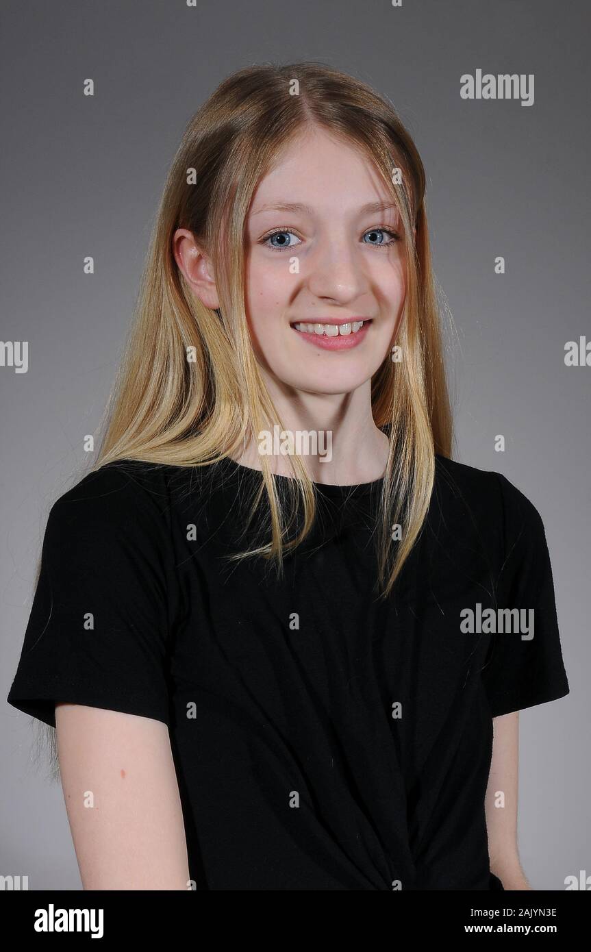 Pretty Blonde Haired Caucasian Teenage Girl In A Black T Shirt