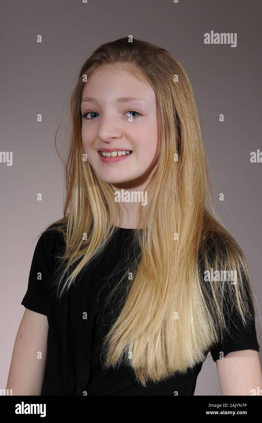 Pretty Blonde Haired Caucasian Teenage Girl In A Black T Shirt