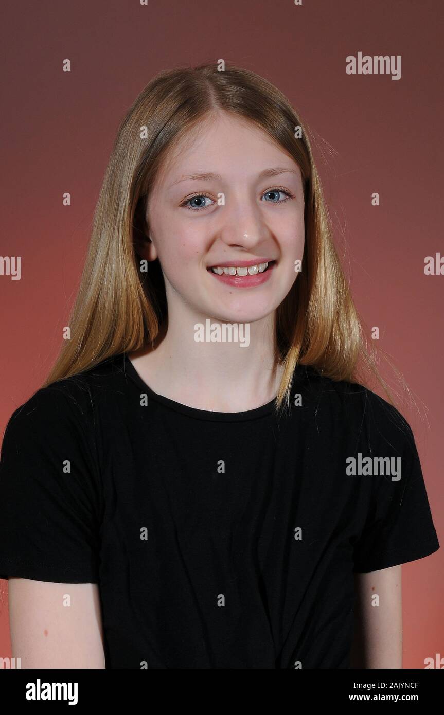Pretty Blonde Haired Caucasian Teenage Girl In A Black T Shirt