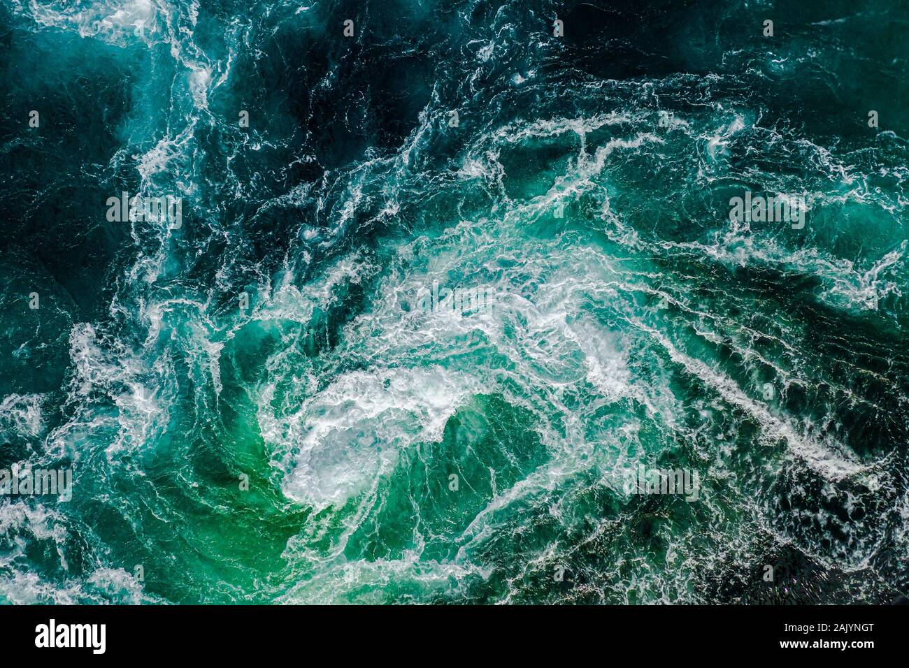 Abstract background. Waves of water of the river and the sea meet each other during high tide and low tide. Whirlpools of the maelstrom of Saltstraume Stock Photo