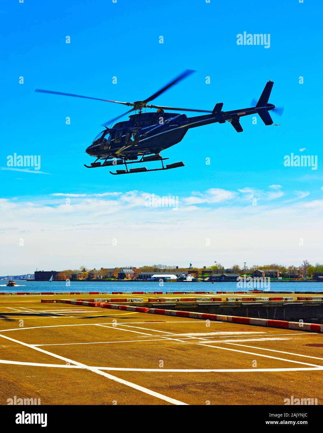 Black Helicopter landing on helipad in Lower Manhattan New York reflex