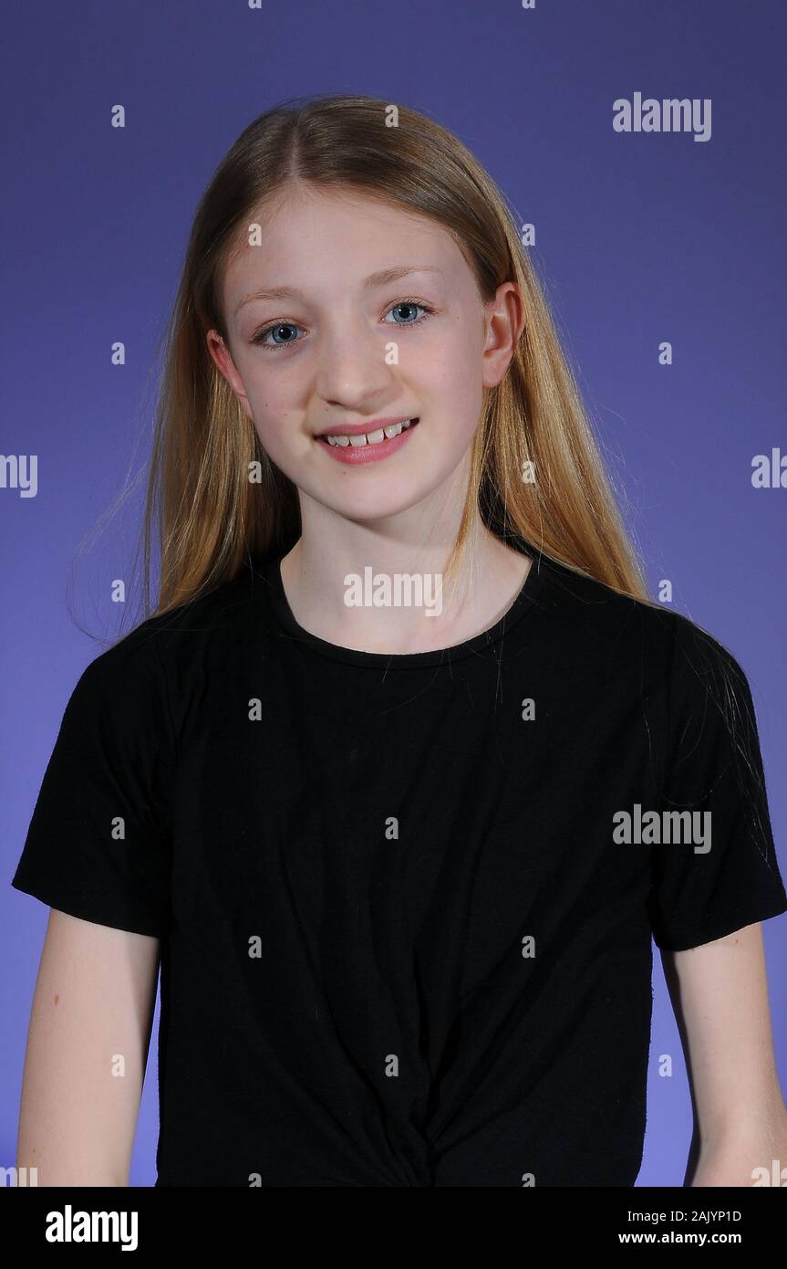 Pretty Blonde Haired Caucasian Teenage Girl In A Black T Shirt