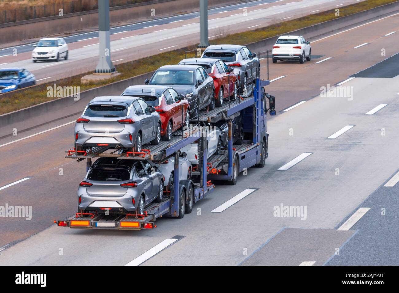 Transportation of new cars on a trailer with a truck for delivery to