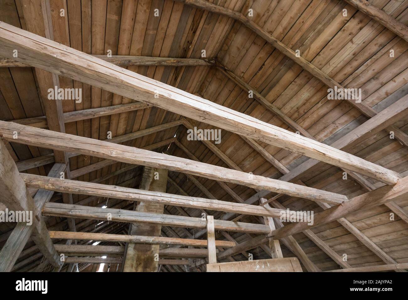 Old and dusty creepy wooden attic with roof framework structure of the old house Awesome horror attic Stock Photo