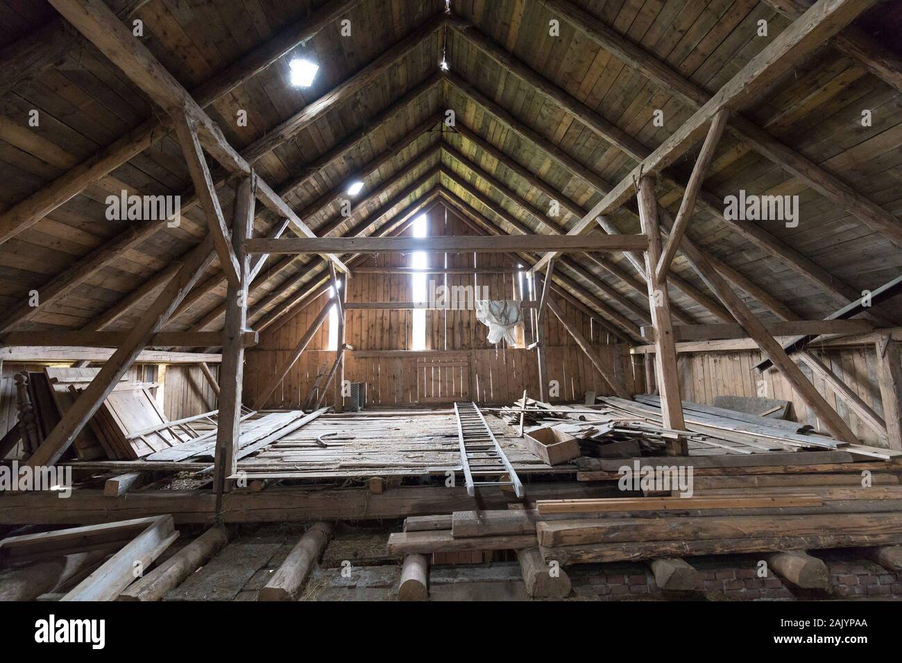 Old and dusty creepy wooden attic with roof framework structure of the old house Awesome horror attic Stock Photo