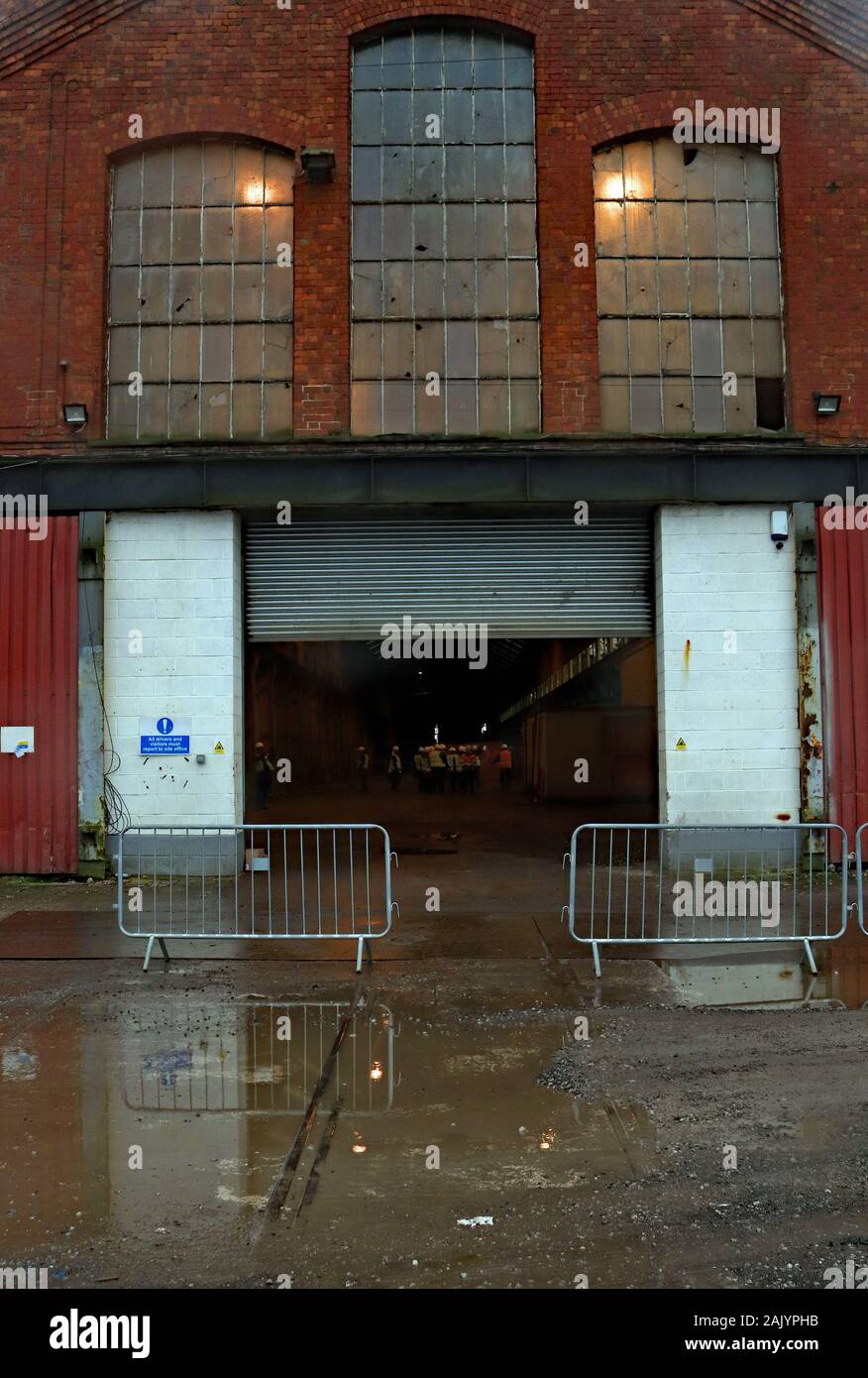 Outside the erecting shop of the former railway locomotive works at Horwich near Bolton with a bit of track still remaining on a big demolition job. Stock Photo