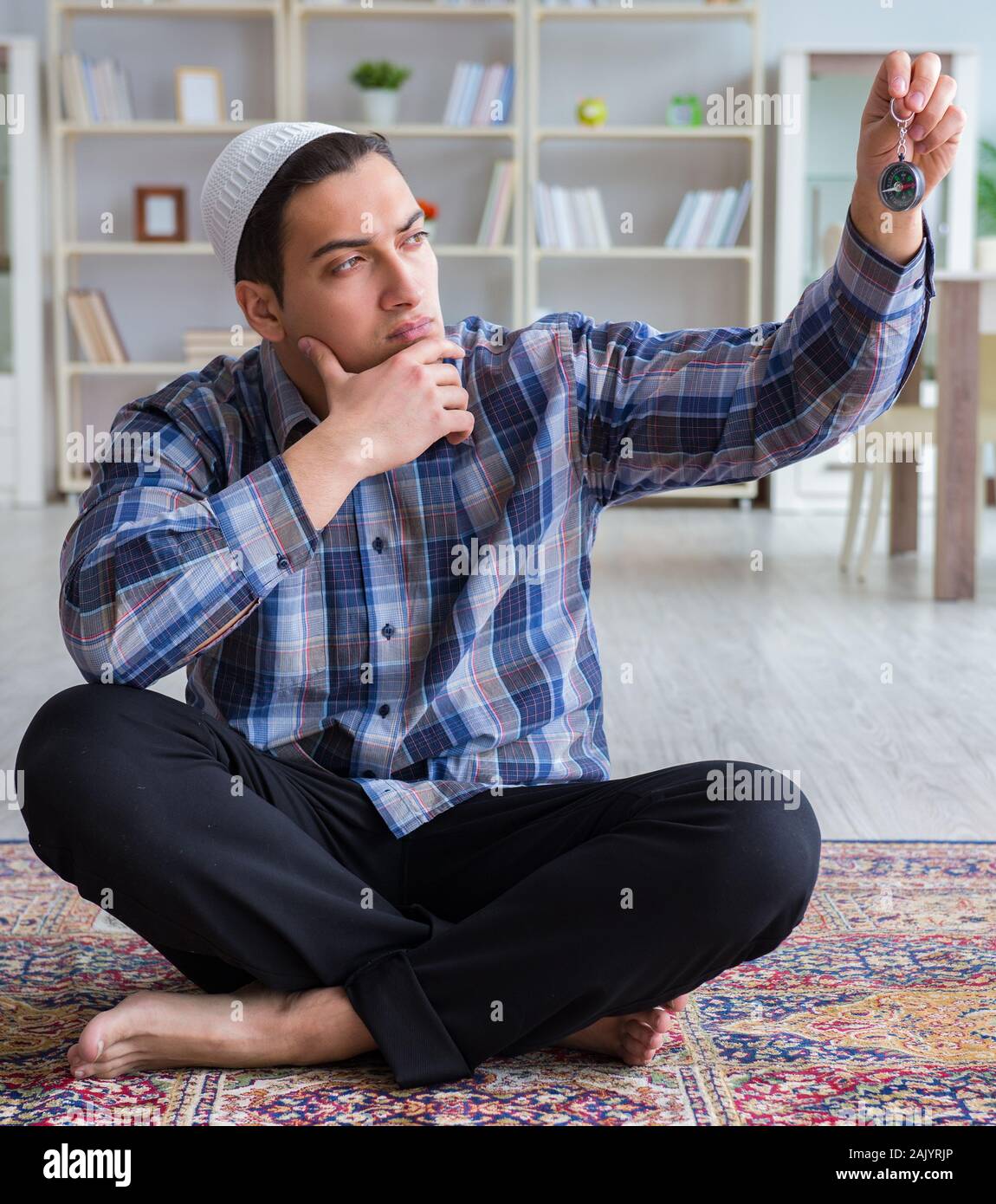 The young muslim man praying at home Stock Photo