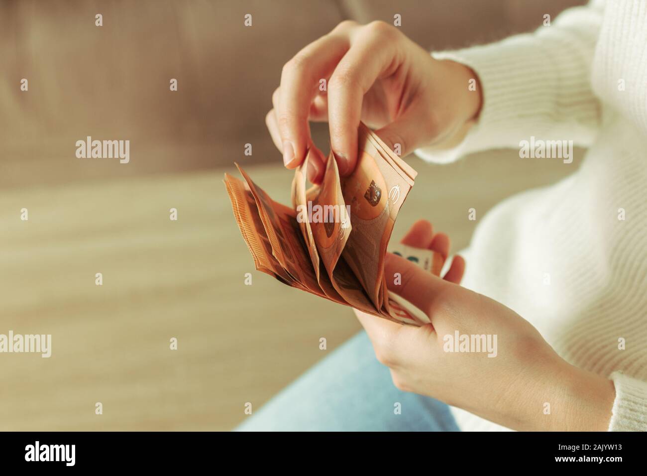 Stock photo of a woman's hands counting 50 euro bills Stock Photo