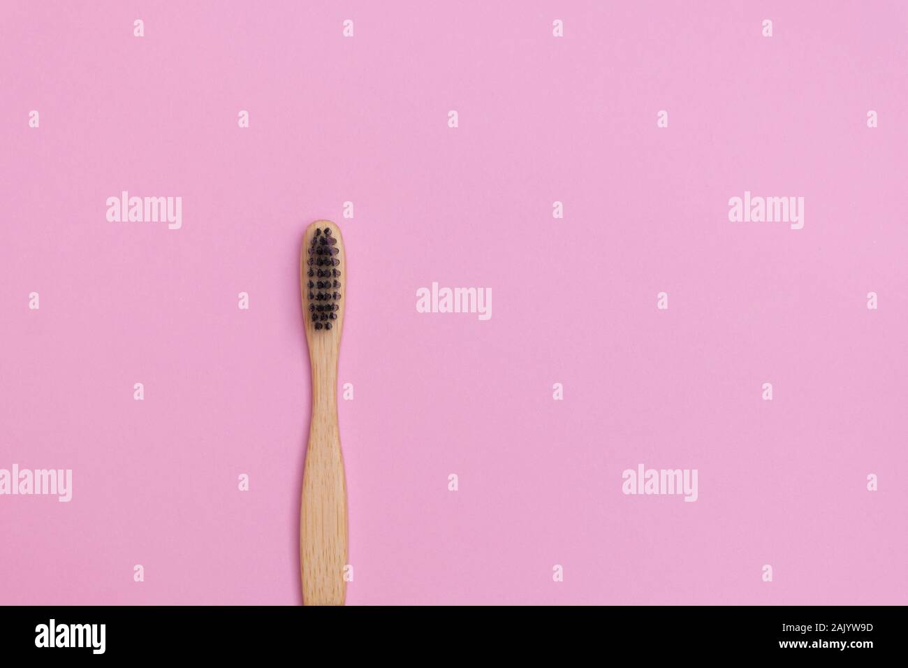 Top view of eco-friendly bamboo toothbrush on soft pink background Stock Photo