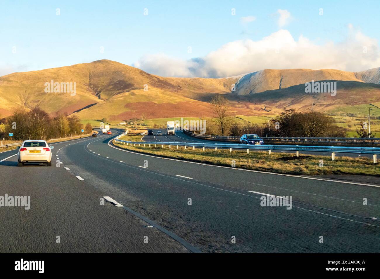 Passing through the edge of the English Lake District on a winter's afternoon going north on the M6 south of Tebay, Cumbria UK Stock Photo