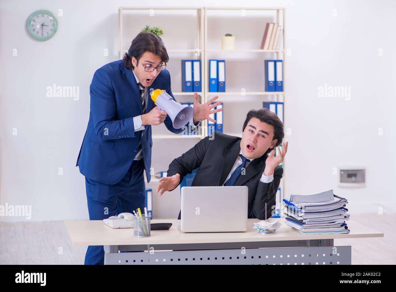 The boss and his male assistant working in the office Stock Photo - Alamy