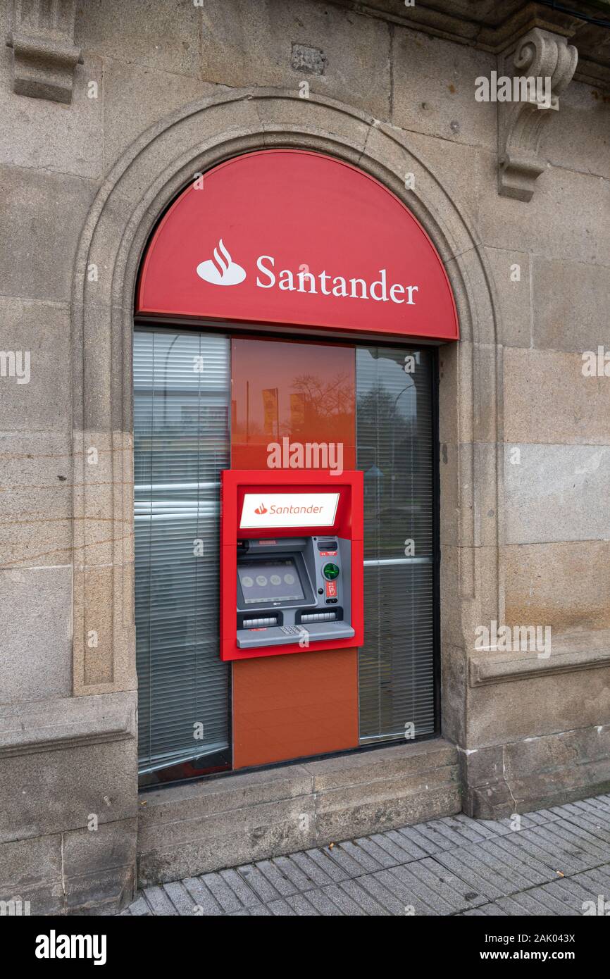 Galicia, Spain; January 02, 2020: Banco Santander cash machine on old building Stock Photo