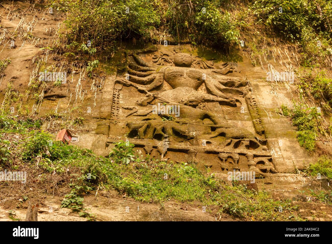 An ancient sculpture of the Hindu goddess Durga carved on the steep mountain wall around the village of Chabimura in Tripura, India. Stock Photo