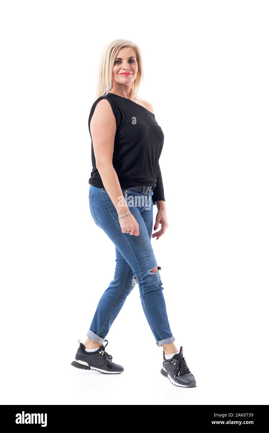 Confident attractive blond hair middle aged woman in fifties in casual clothes posing and smiling. Full body length isolated on white background. Stock Photo