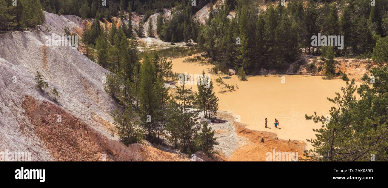 people in the water and on the beach in a water-flooded sandpit where sand was previously mined, summer day, Lom Sec, Czech republic Stock Photo