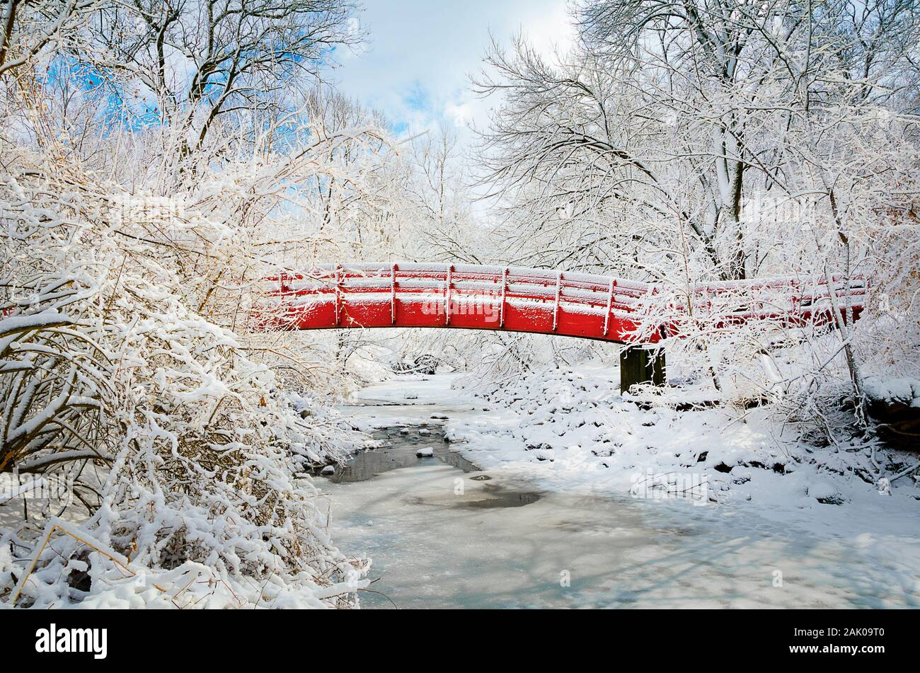 Fresh snowfall on red bridge Stock Photo
