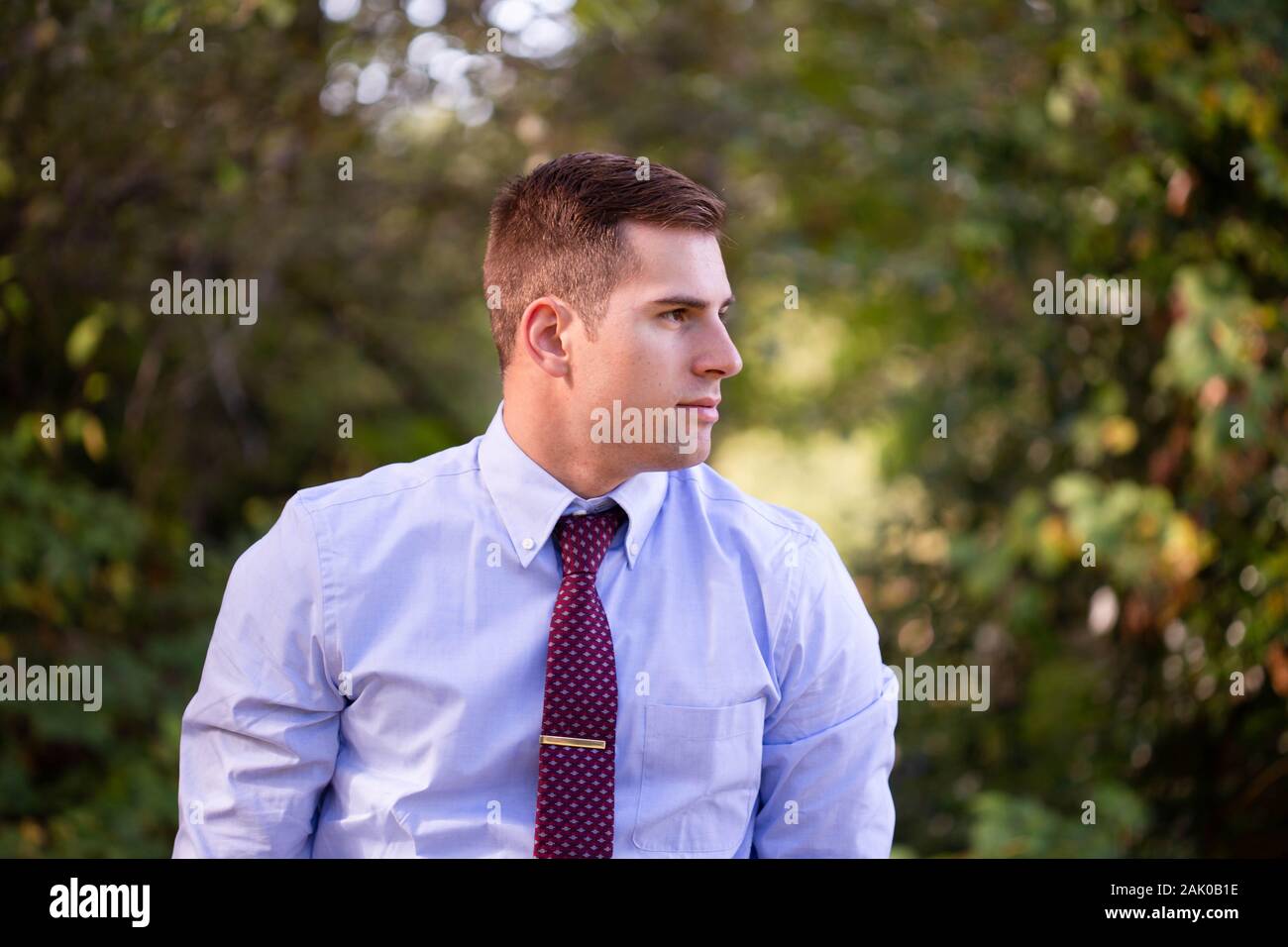 Young white man stands outside in Pacific Northwest showing profile Stock Photo