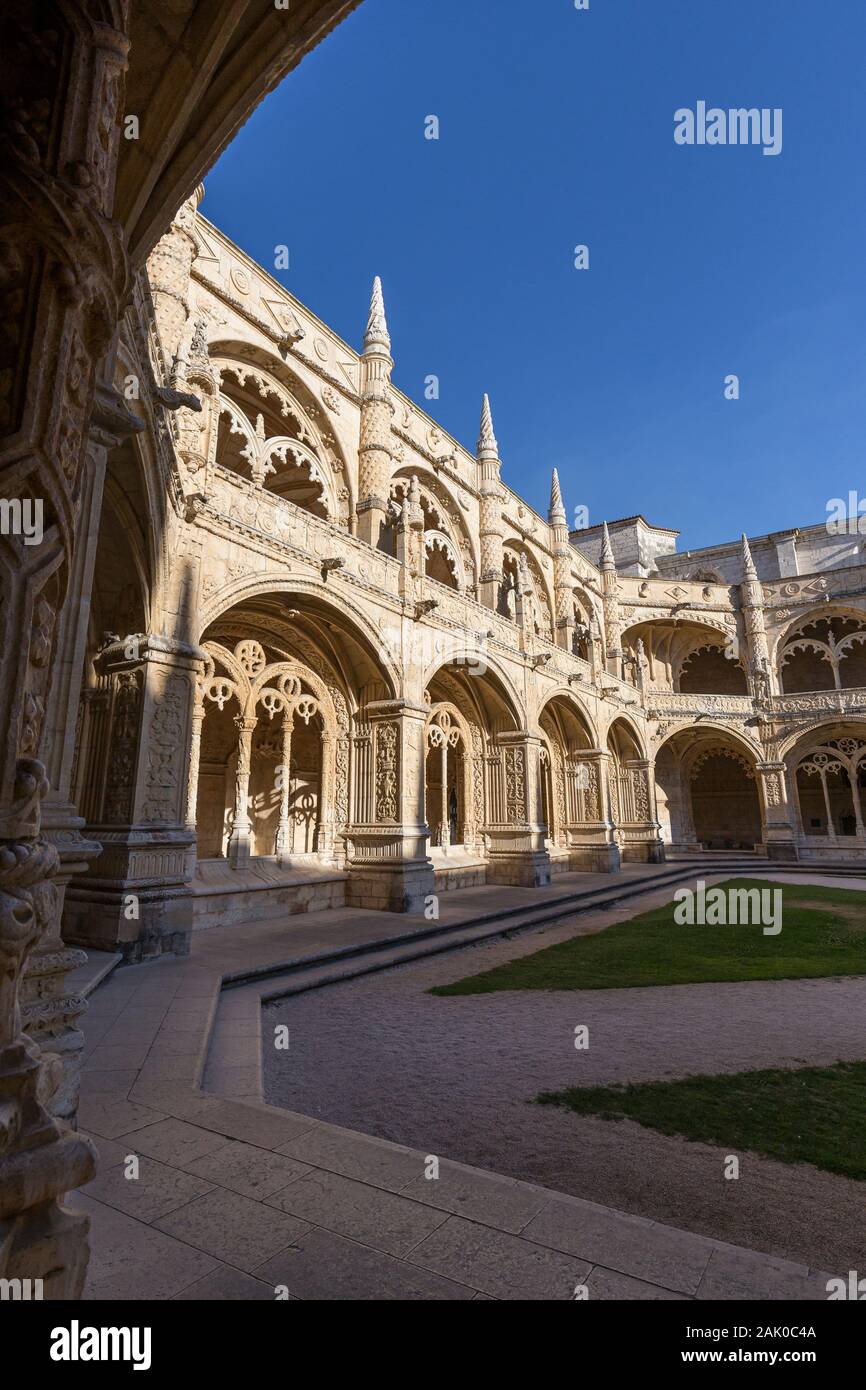 Empty inner courtyard and ornamental cloisters at the historic Manueline style Mosteiro dos Jeronimos (Jeronimos Monastery) in Belem, Lisbon, Portugal Stock Photo
