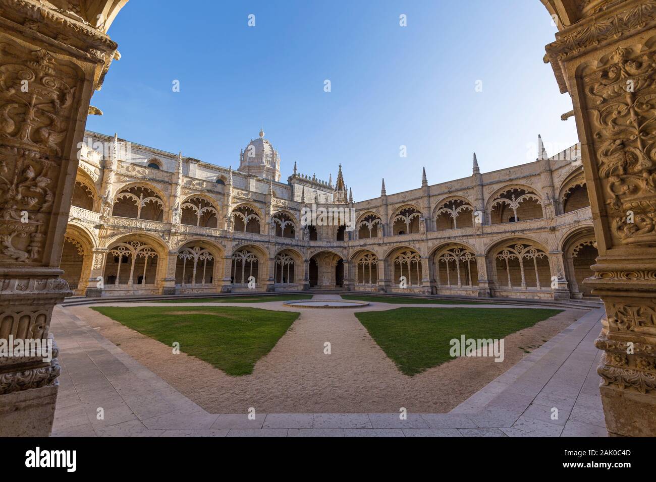 Empty inner courtyard between the ornamental cloisters at the historic Manueline style Mosteiro dos Jeronimos (Jeronimos Monastery) in Belem, Lisbon. Stock Photo