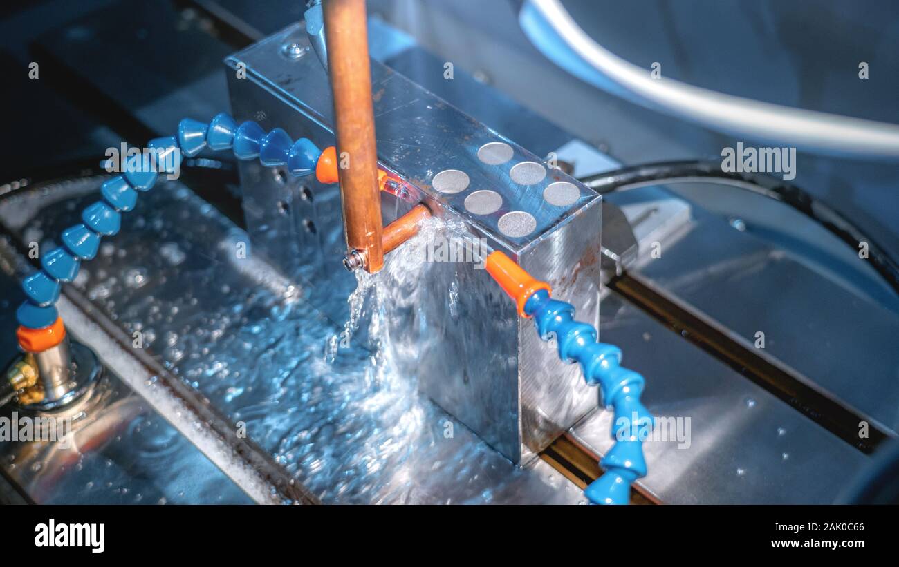 CNC machine cutting metal parts by water jet pressure Stock Photo