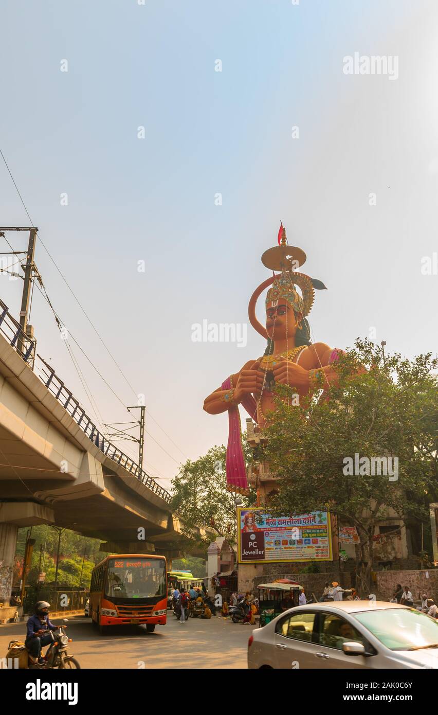 City Traffic overlooking The Hanuman temple near Karol Bagh Delhi with giant 108 feet statute of Lord Hanuman . Stock Photo