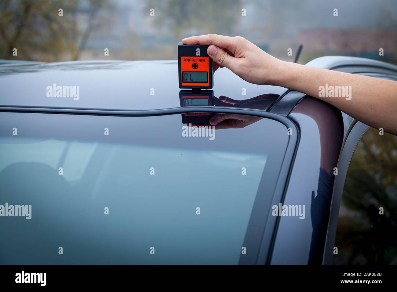 Measuring the thickness of the car paint coating in black color using a