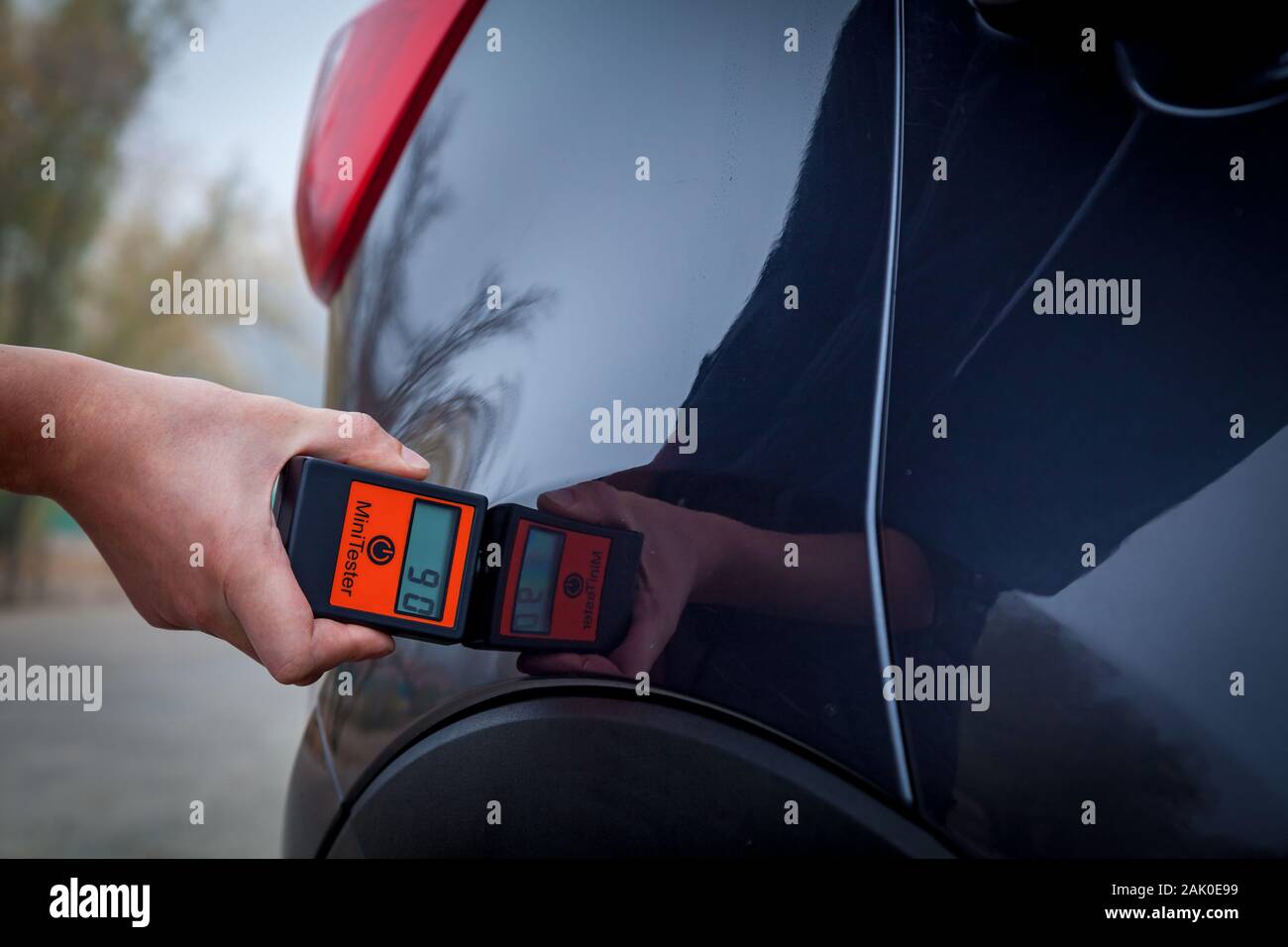 Measuring the thickness of the car paint coating in black color using a