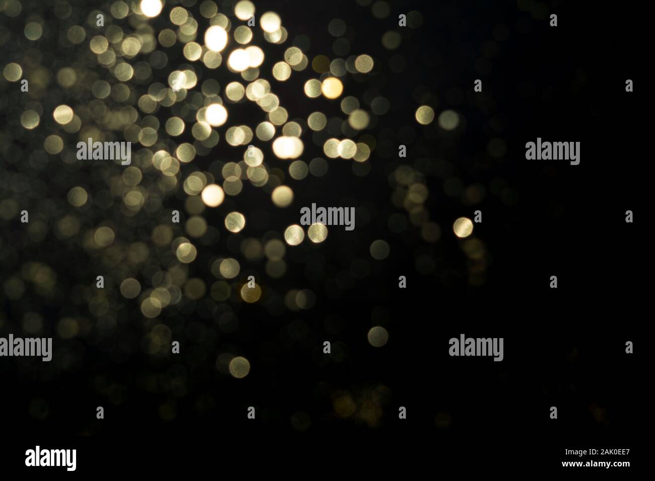 Abstract blurred glitter bokeh background in gold, on black Stock Photo ...