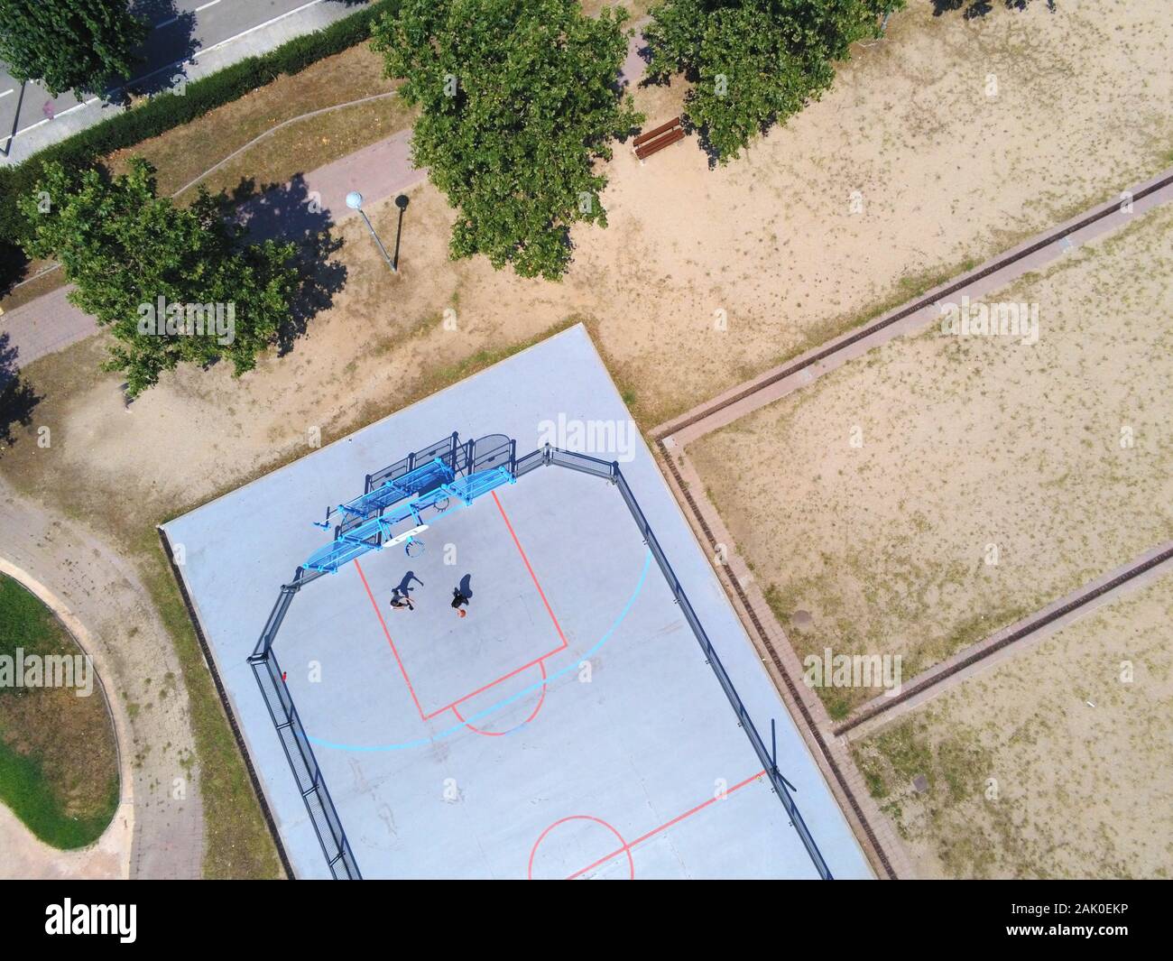 Aerial view of two unrecognizable teen playing basket on a urban court in sunny day Stock Photo