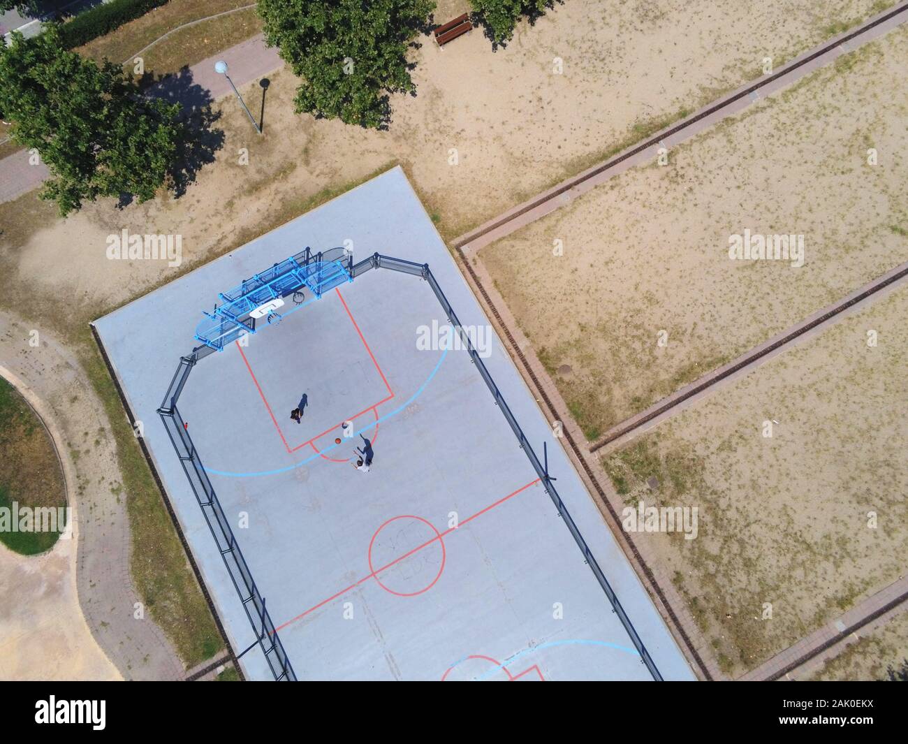 Aerial view of two unrecognizable teen playing basket on a urban court in sunny day Stock Photo