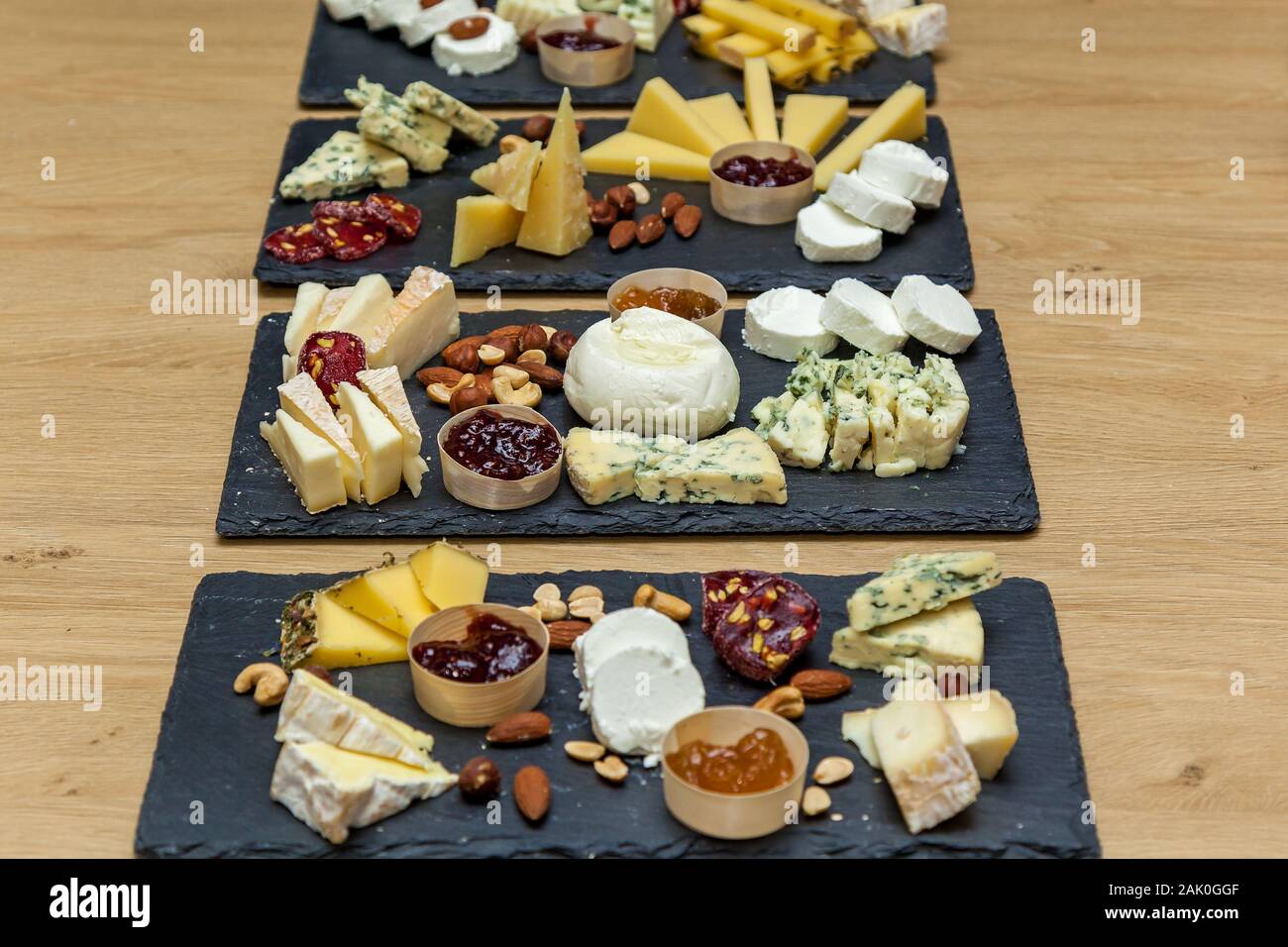 Cheese plates served with jam, nuts, honey at the presentation from