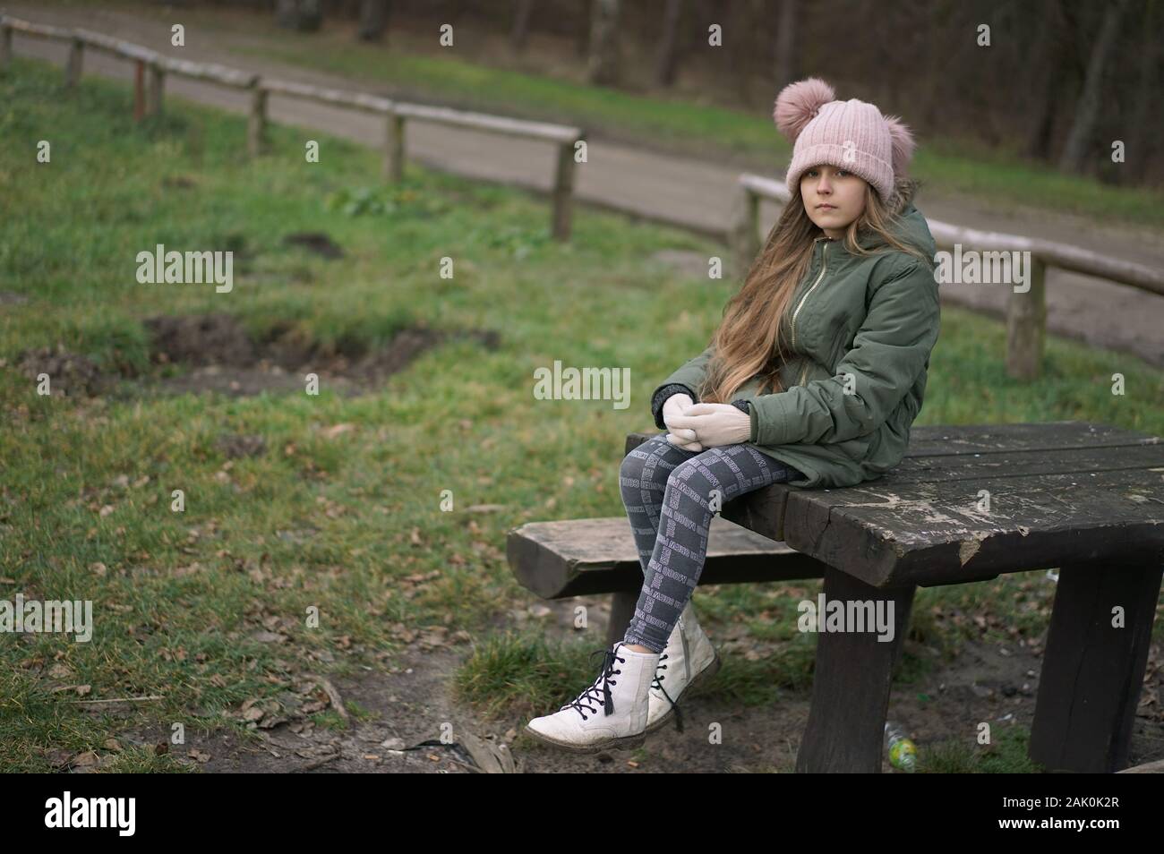 girl sitting on a bench in the park Stock Photo - Alamy