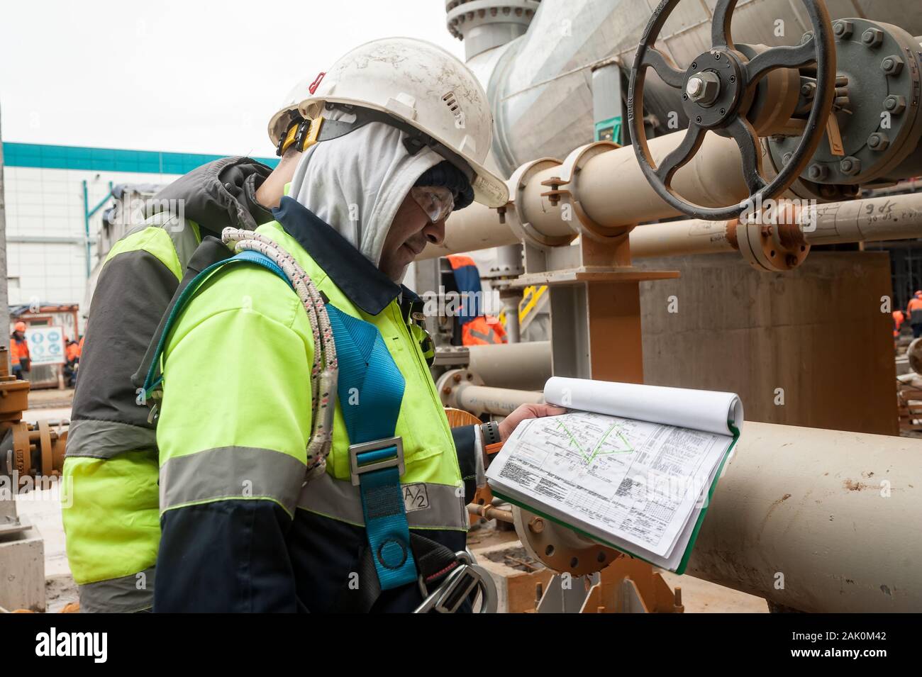 Worker on a construction site looking documents Stock Photo