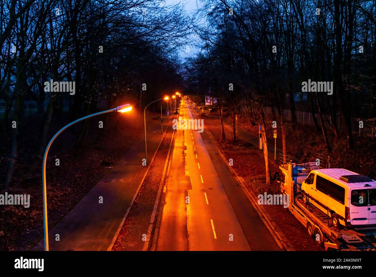 Inner city street, LŸhrmannstrasse, avenue, lanterns, no traffic, in the evening in winter, Essen, Germany, Stock Photo