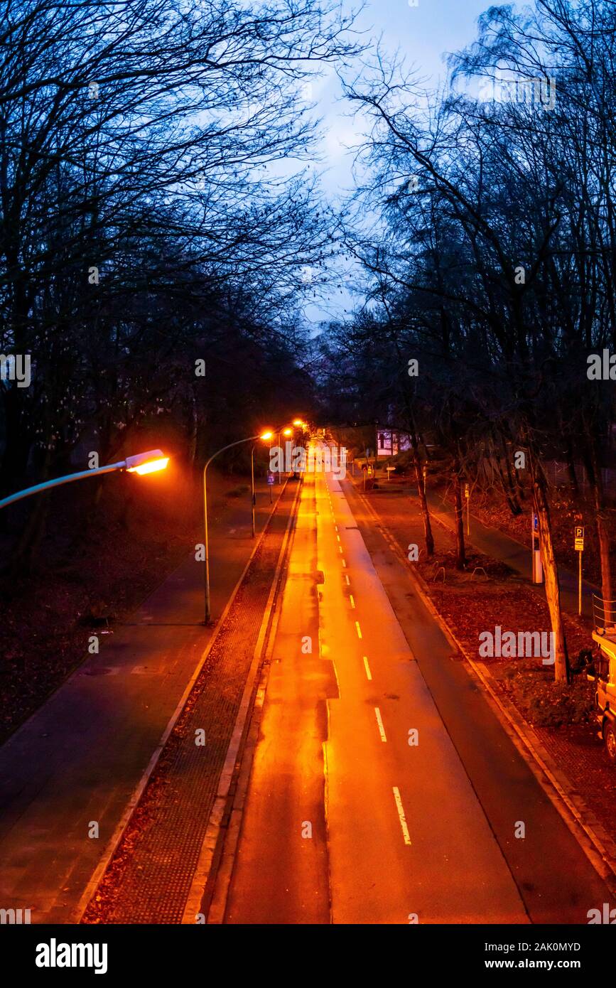 Inner city street, LŸhrmannstrasse, avenue, lanterns, no traffic, in the evening in winter, Essen, Germany, Stock Photo