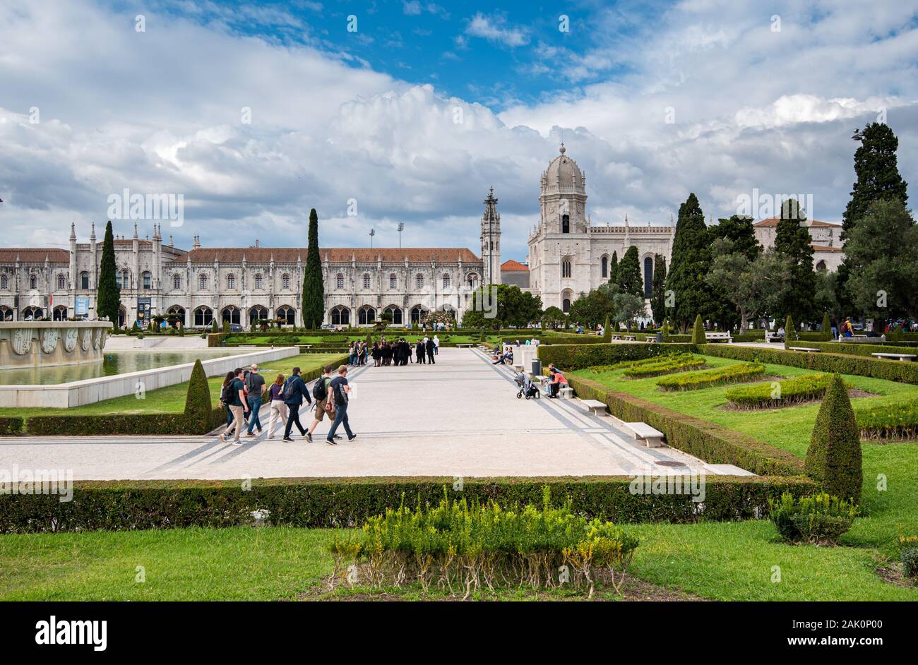 Tourist people walking outside the park facing the Jeronimos Monastery or Hieronymites Monastery near Tagus river in Lisbon Portugal Stock Photo