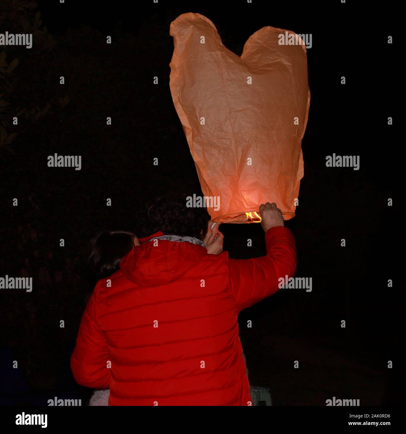 A person is launching a chinese lantern during new year celebration Stock Photo