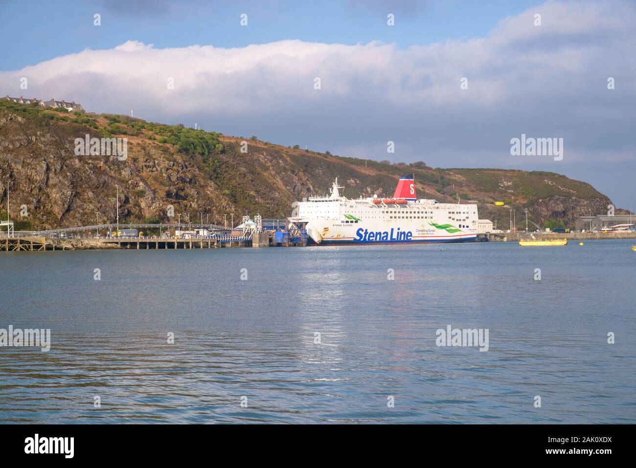 A ferry lies on the hilly coastline of Fishguard in Pembrokeshire, in