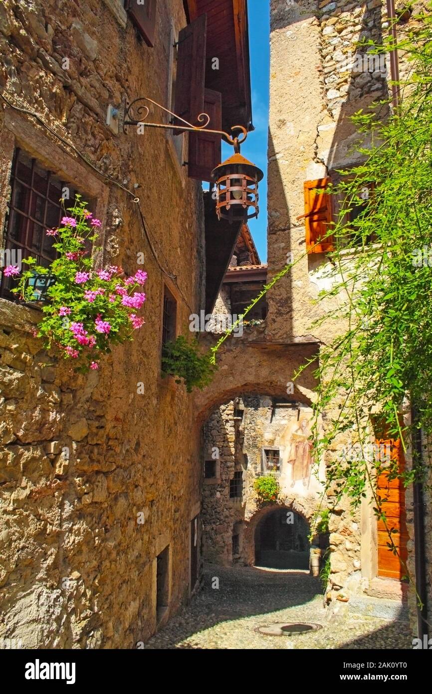 Beautiful medieval village, hisoric village in the mountains with houses with stone walls and flowers in the windows, cobbled streets Stock Photo