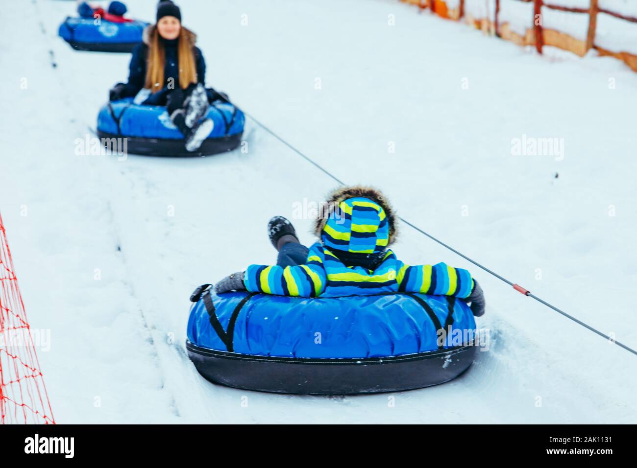 snowing tubes pulling up by hill. families leisure time Stock Photo Alamy