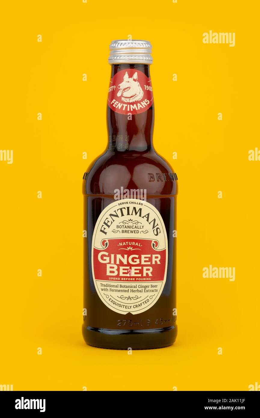 A bottle of Fentimans Ginger Beer shot on a yellow background. Stock Photo