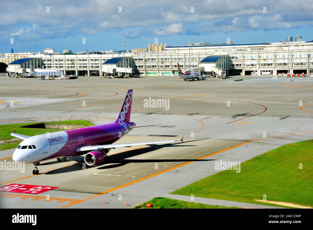 Naha Airport (ROHA), Aerial, With Peach Aviation Airbus, A320, Waiting for Departure, Naha, Okinawa, Japan Stock Photo