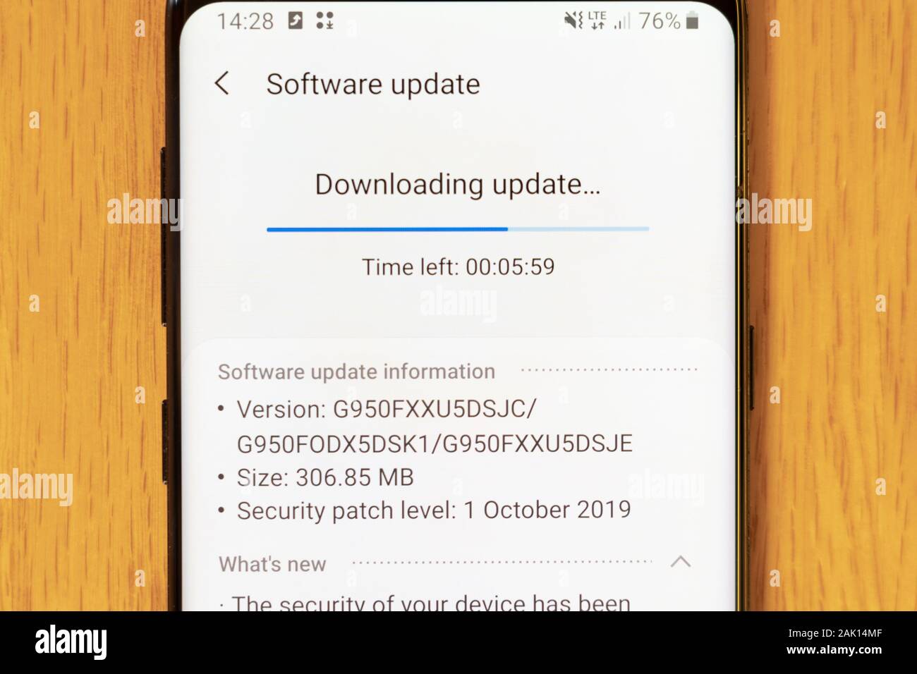 A Galaxy S8 smartphone downloading a system update and security patch Stock Photo