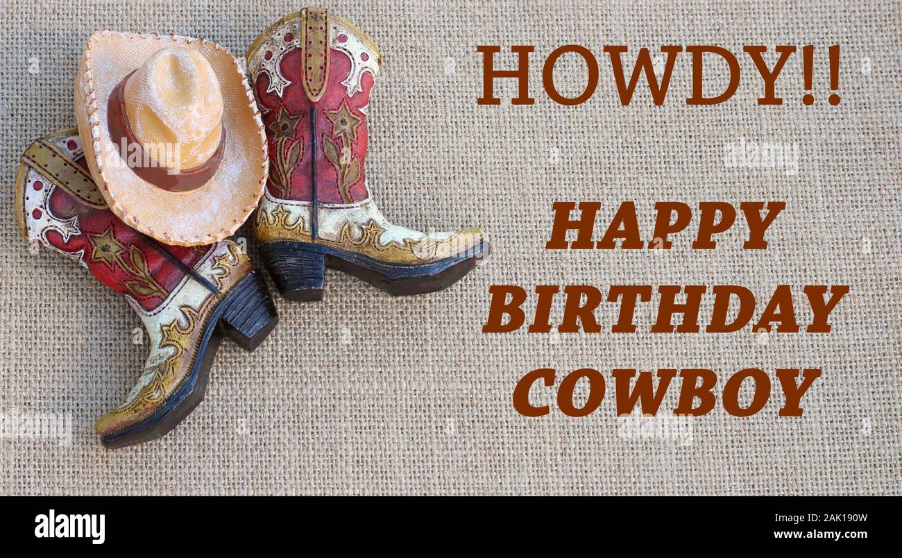 cowboy boots and hat with howdy happy birthday message in rust colored text Stock Photo