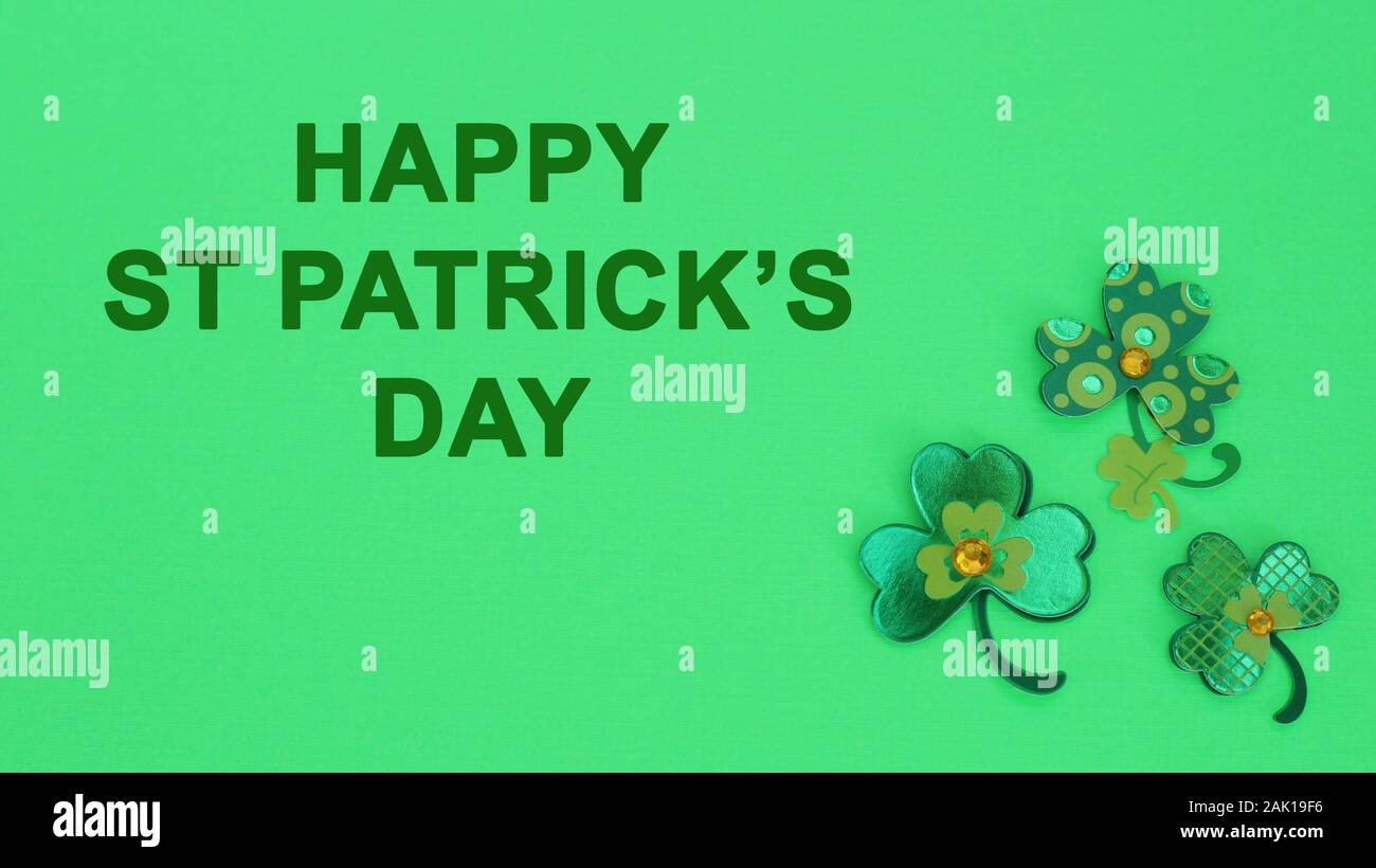 three clovers on a green background with happy st Patricks day message Stock Photo