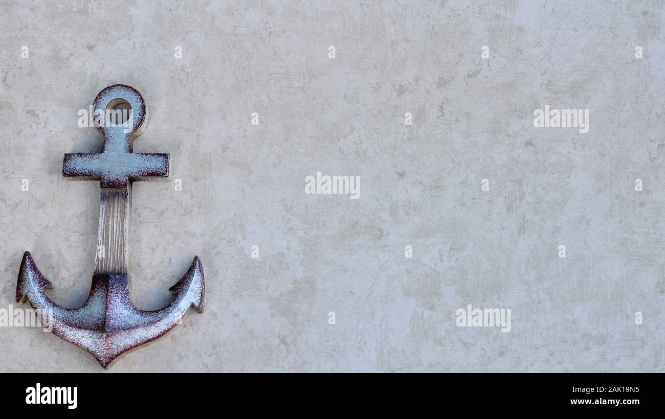 decrative ship anchor isolated on a tan background with writing space Stock Photo
