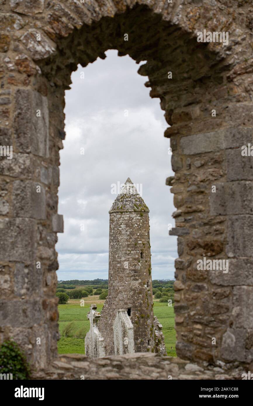 Archaeological site of Clonmacnoise in Ireland with a cathedral, churches, a graveyard, grave slabs, and several temples, towers and crosses Stock Photo