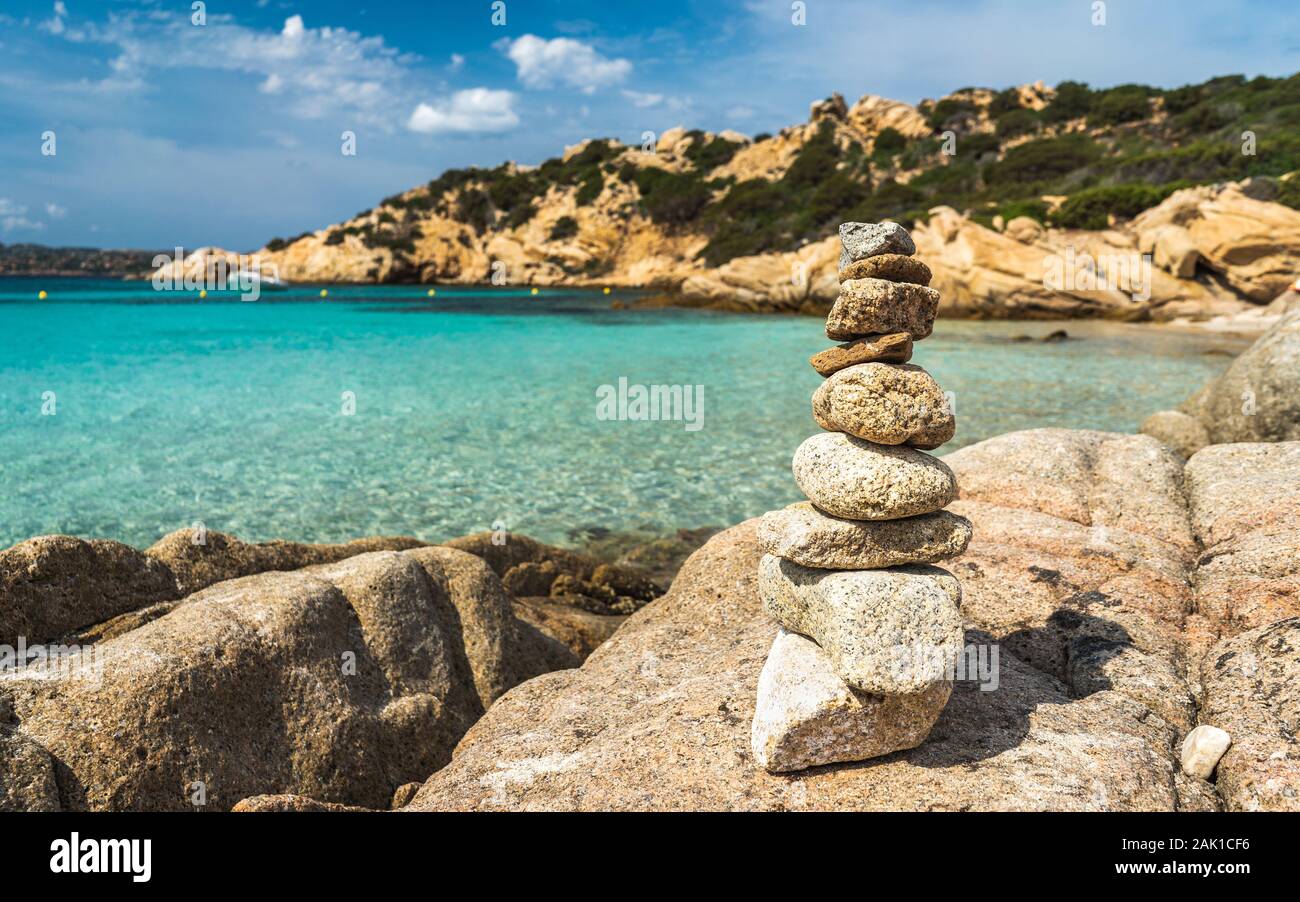 Stacked stones on the most beautiful beaches of Sardinia. Paradise place for vacations. Stacked stones and turquoise water. Stock Photo