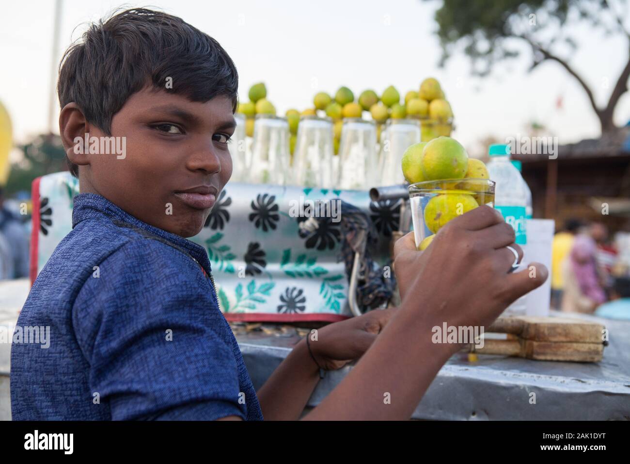 Portrait of a street vendor selling lime-flavoured water in the old city of Delhi, India Stock Photo