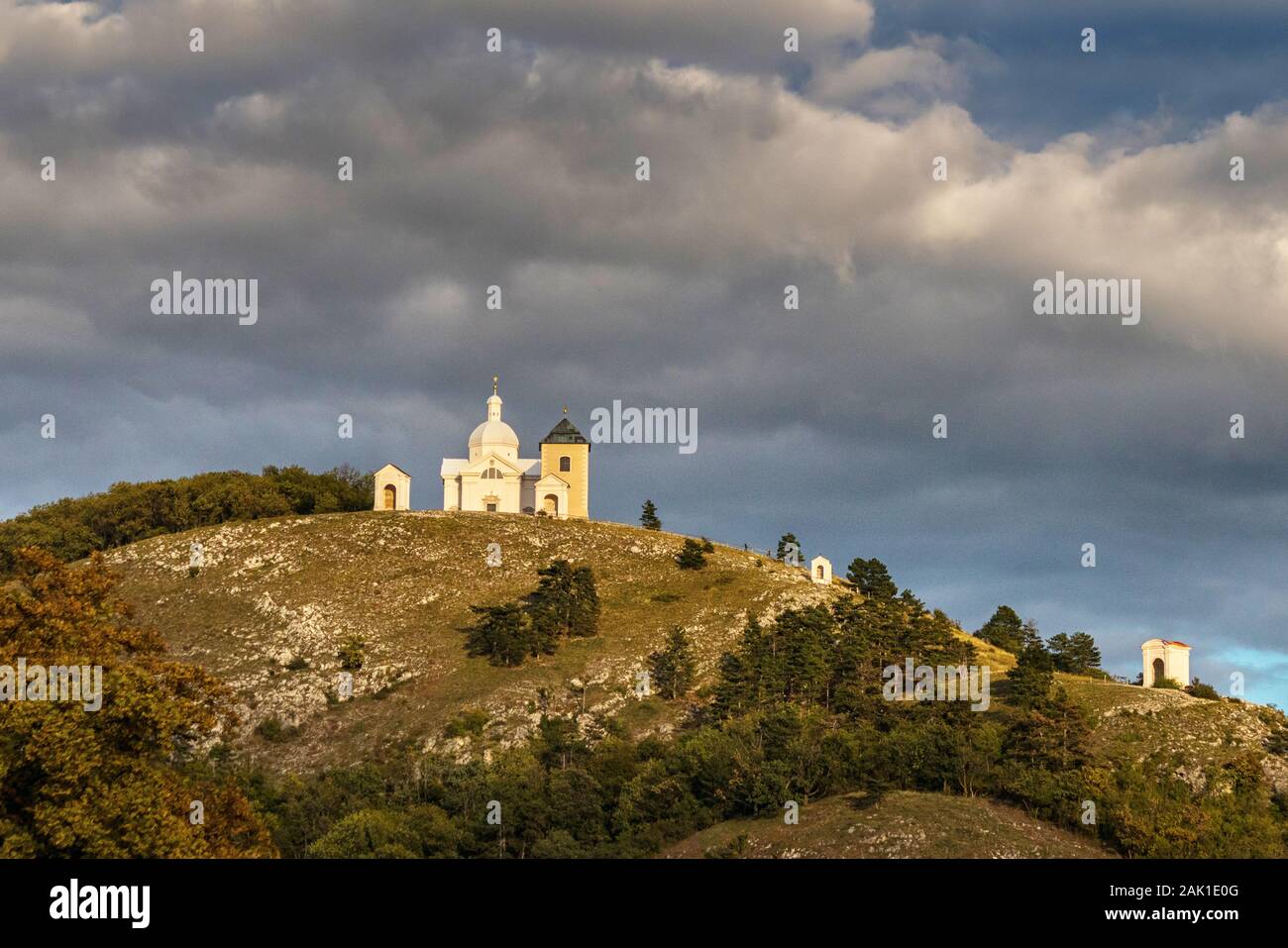 Chapel on a high hill, lit by the setting sun, in the background dramatic sky, Mikulov, Czech republic Stock Photo